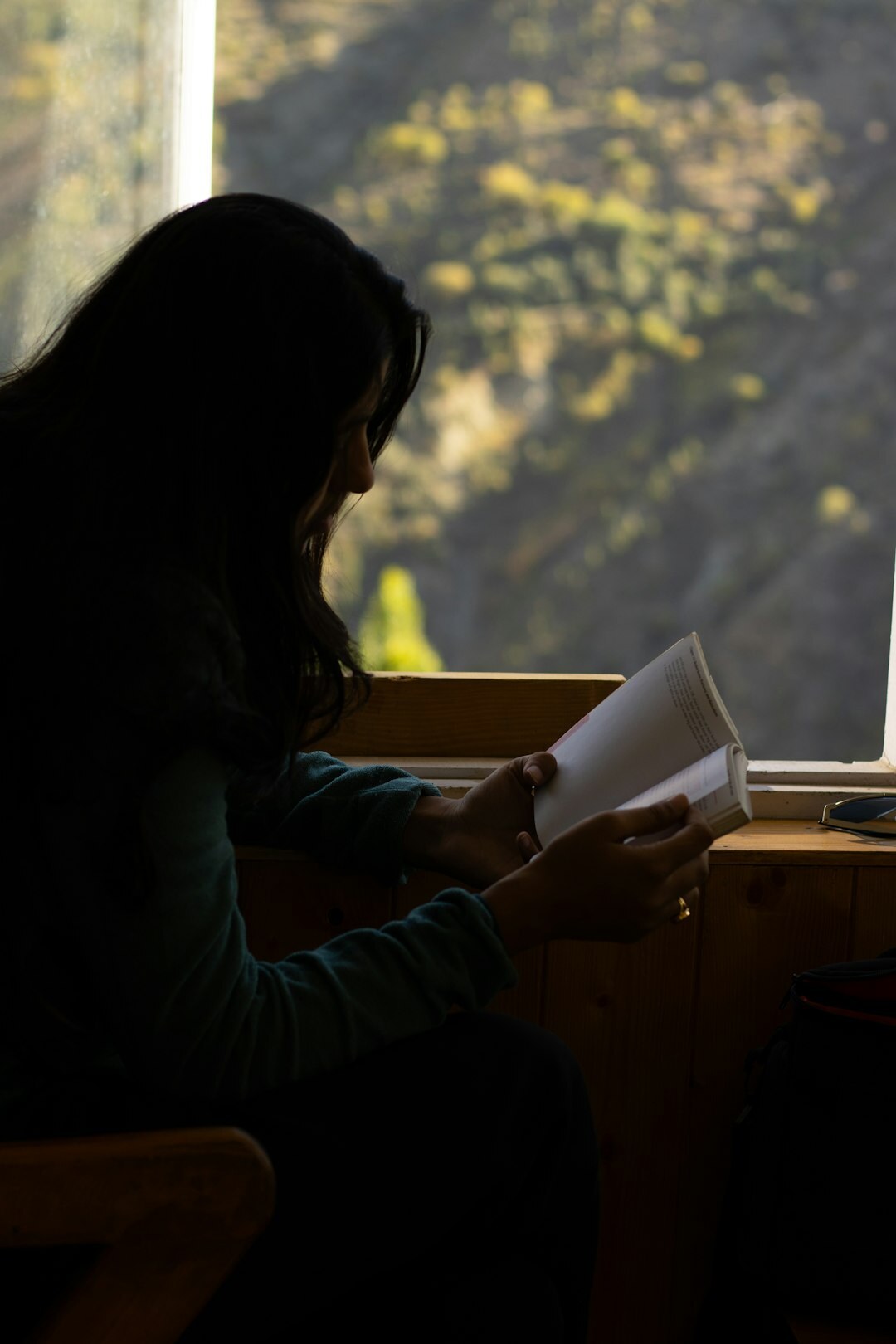 woman reading book in morning light
