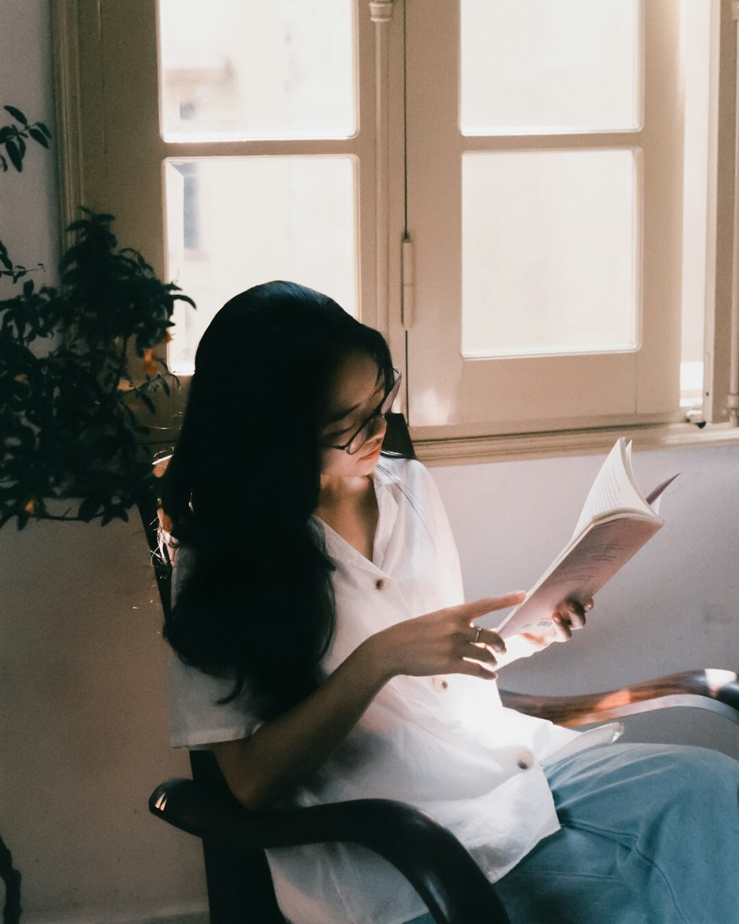 woman reading book in morning light